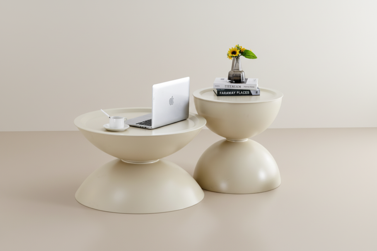 Beige side table with a laptop, mug, and decorative items on a white background