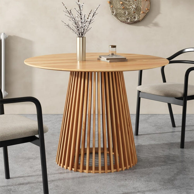 Wooden dining table with a unique base design in a room setting.