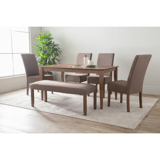Dining room set with wooden table and chairs on a light rug.