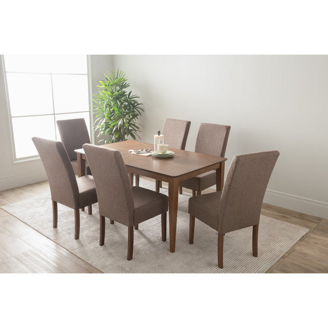 Dining table set with six chairs in a room with a large window and plant.
