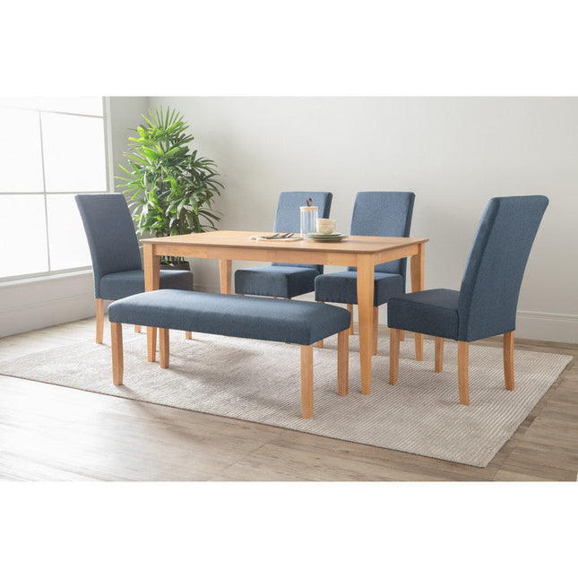 Dining set with wooden table and blue chairs in a room with a plant and rug.