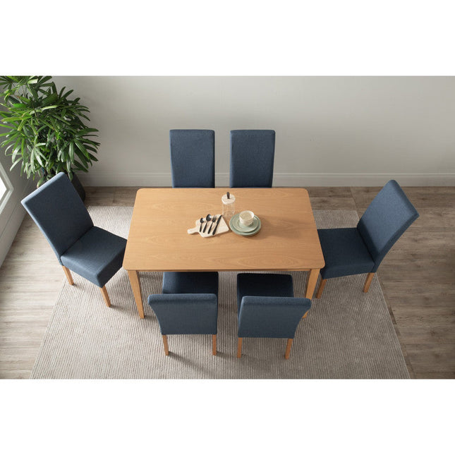 Dining table set with six blue chairs in a room with a plant and neutral decor.