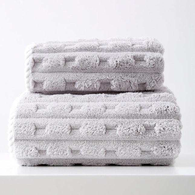 Stack of textured gray towels on a white background