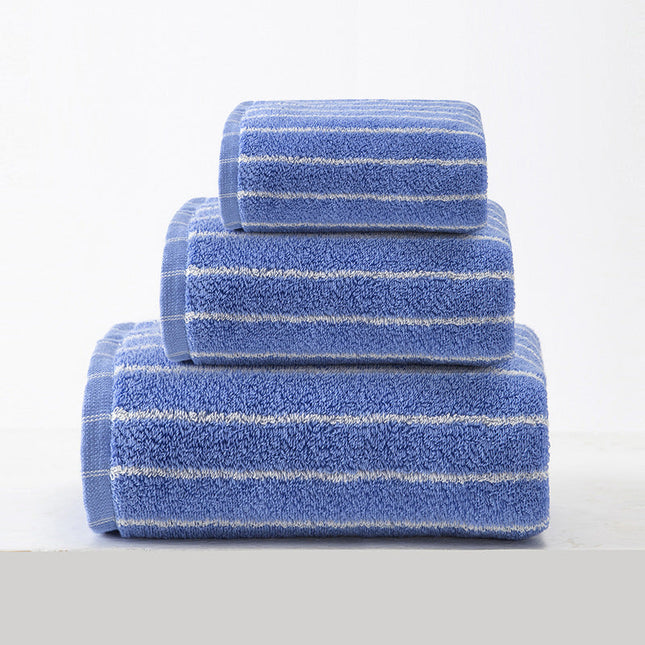 Set of three blue towels with white stripes on a light gray background