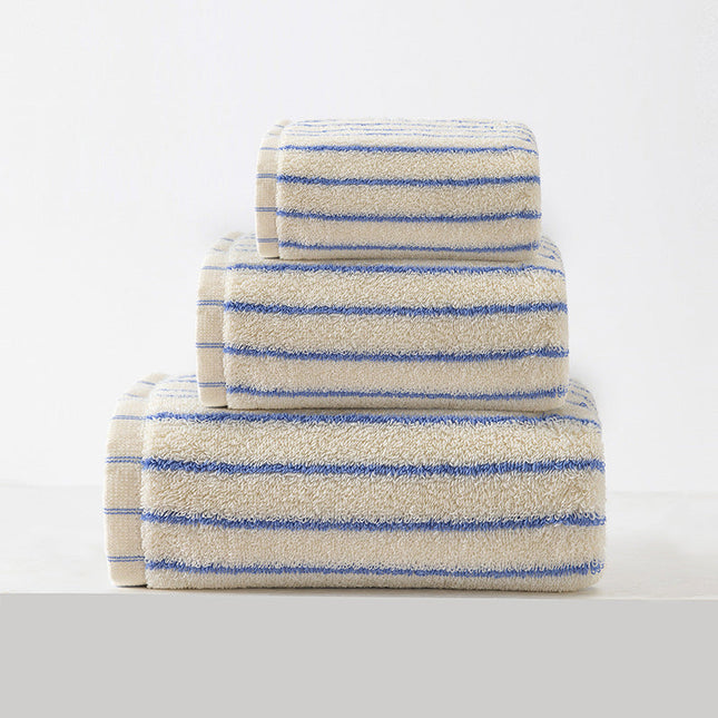 Stack of striped towels with blue and beige pattern on a white background