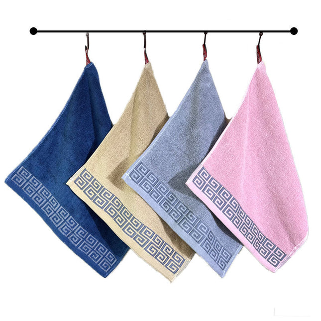 Four colorful towels with geometric patterns hanging on a rod against a white background.