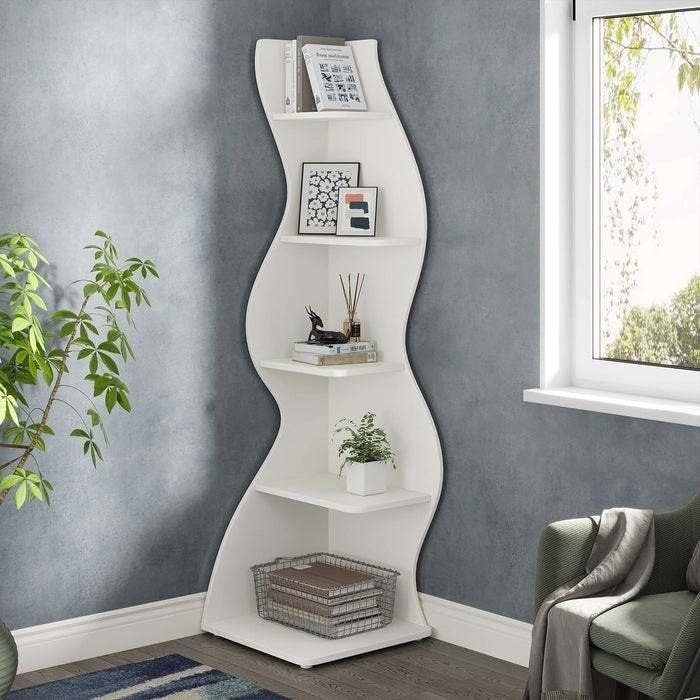 White wavy shelf with decorative items against a gray wall with a window.