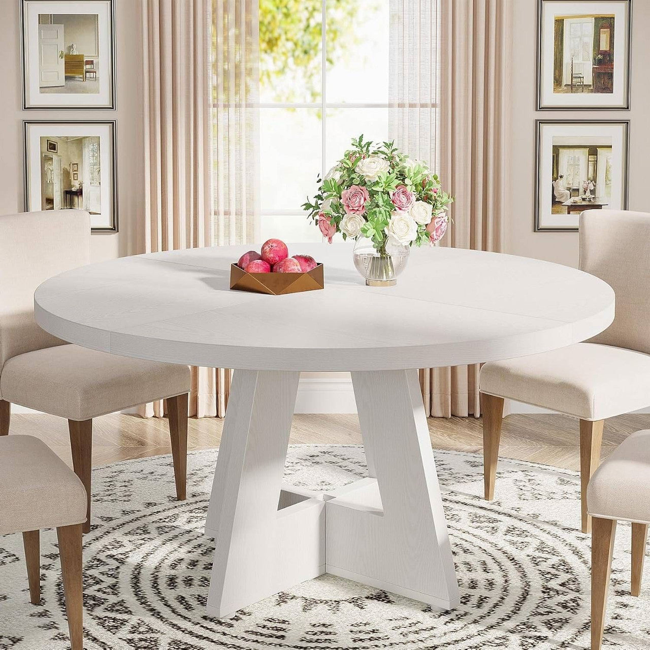 Round white dining table with a vase of flowers in a stylishly decorated room.