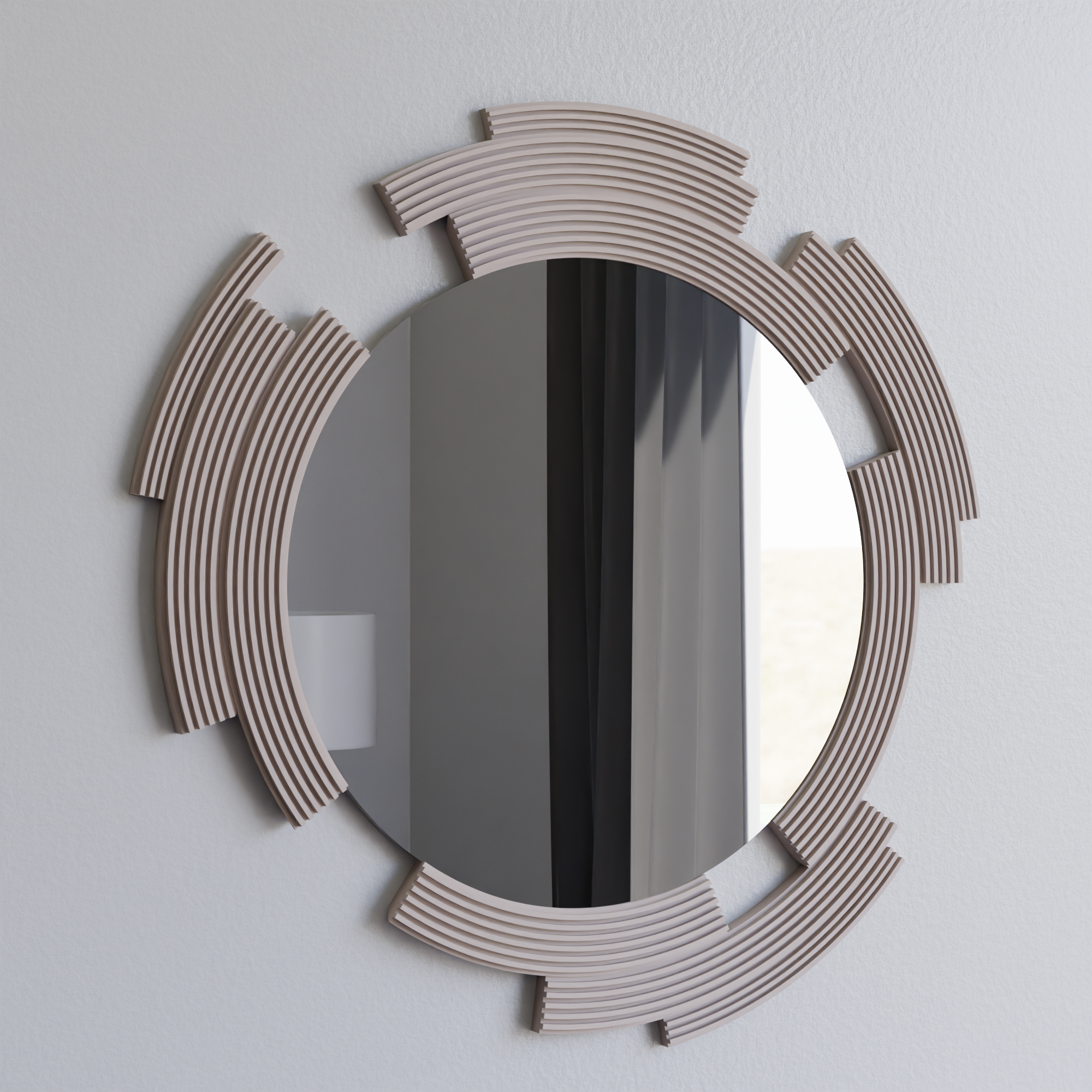 Round mirror with decorative frame on a light gray wall