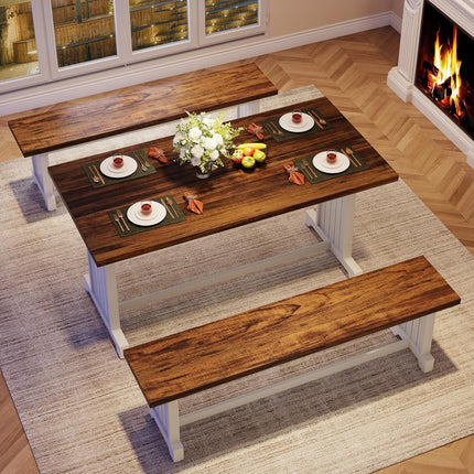 Wooden dining table with benches in a cozy room with a fireplace.