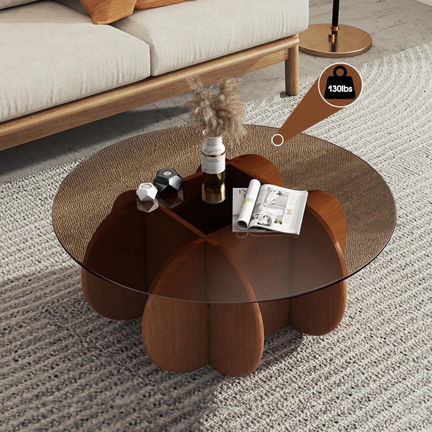Coffee table with glass top and brown base in a living room setting