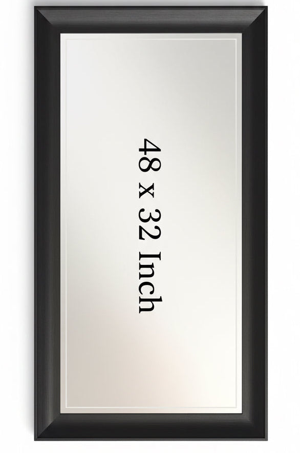 Bedroom with a large mirror on the wall, a nightstand with a lamp, and a bed.