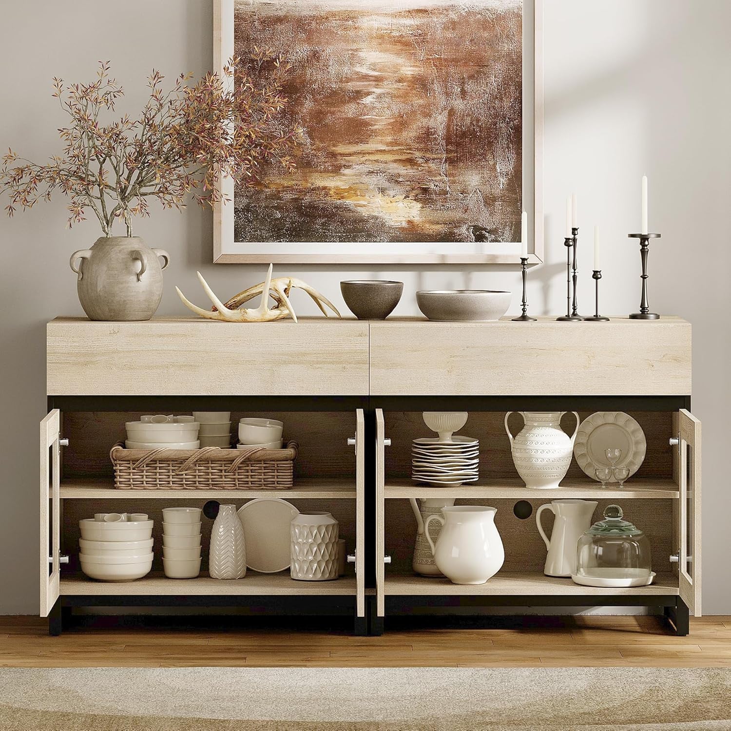 Wooden sideboard with decorative items in a room with abstract art on the wall.