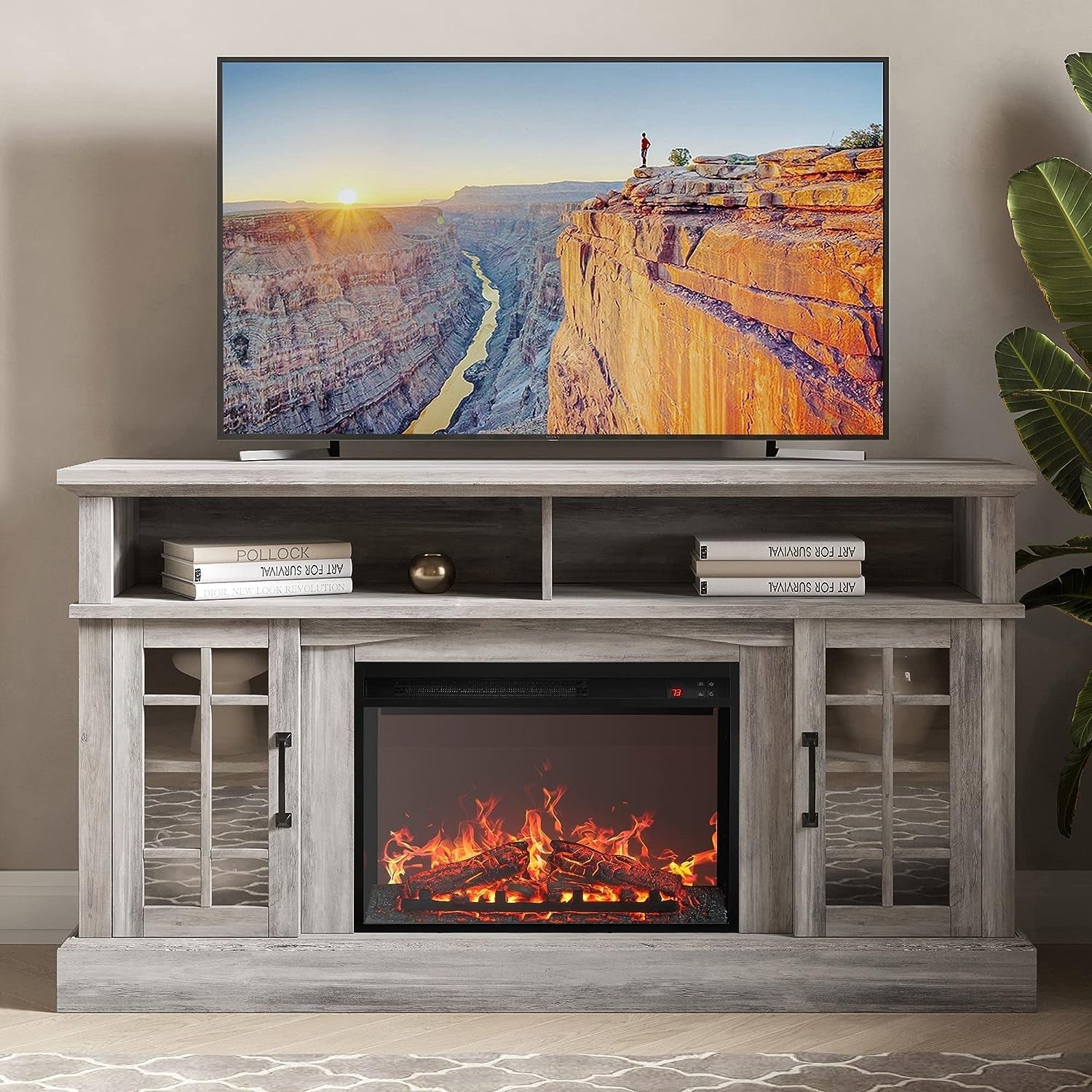 TV mounted on a wooden entertainment center with fireplace insert, displaying a scenic image.