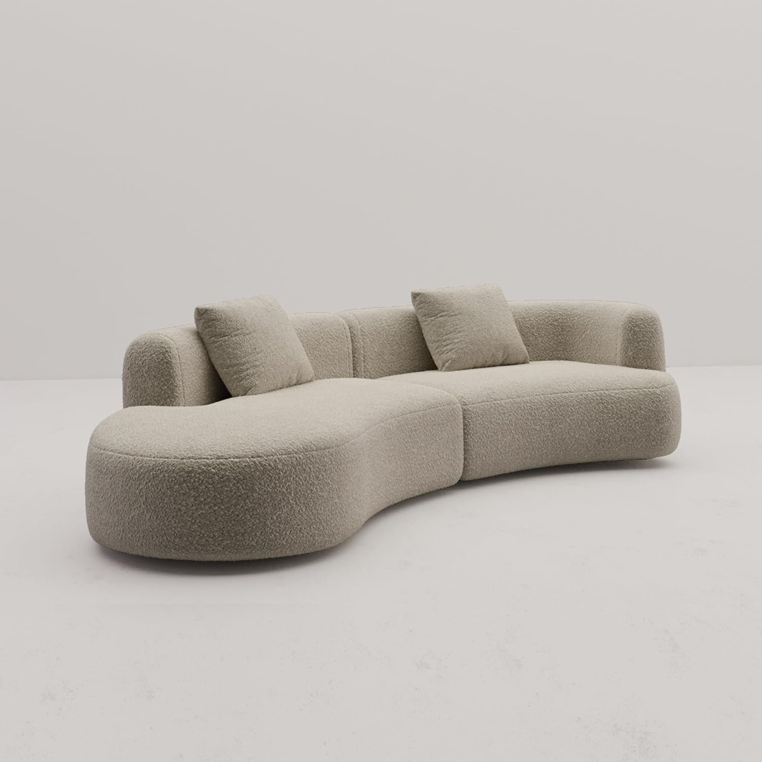 Beige sofa with curved design on a plain background