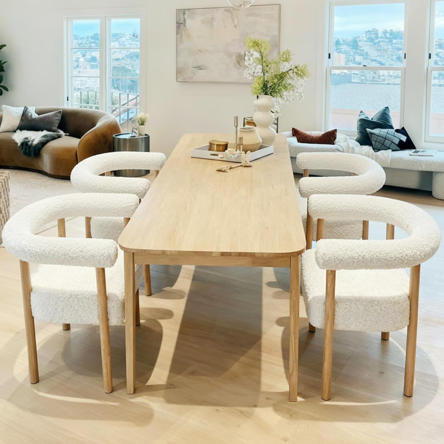 Dining area with a wooden table and chairs in a bright room.