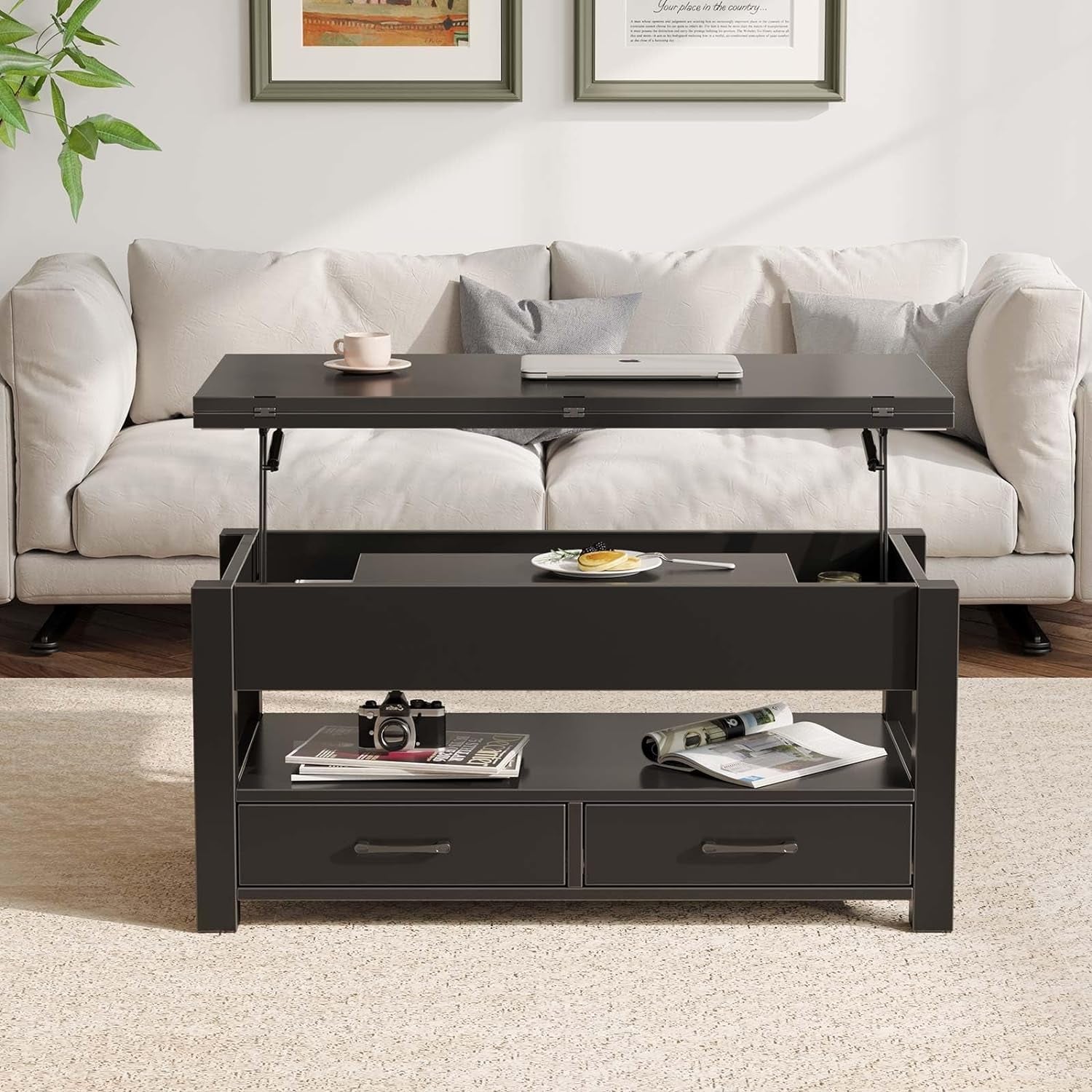 Black lift-top coffee table in a living room setting with a white sofa and framed pictures on the wall.