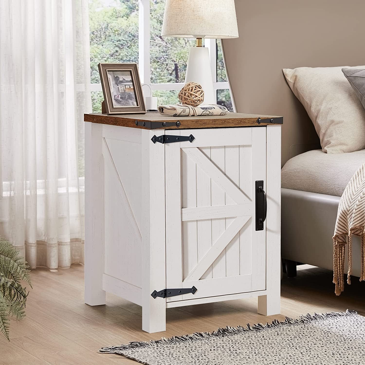 White nightstand with wooden top in a bedroom setting