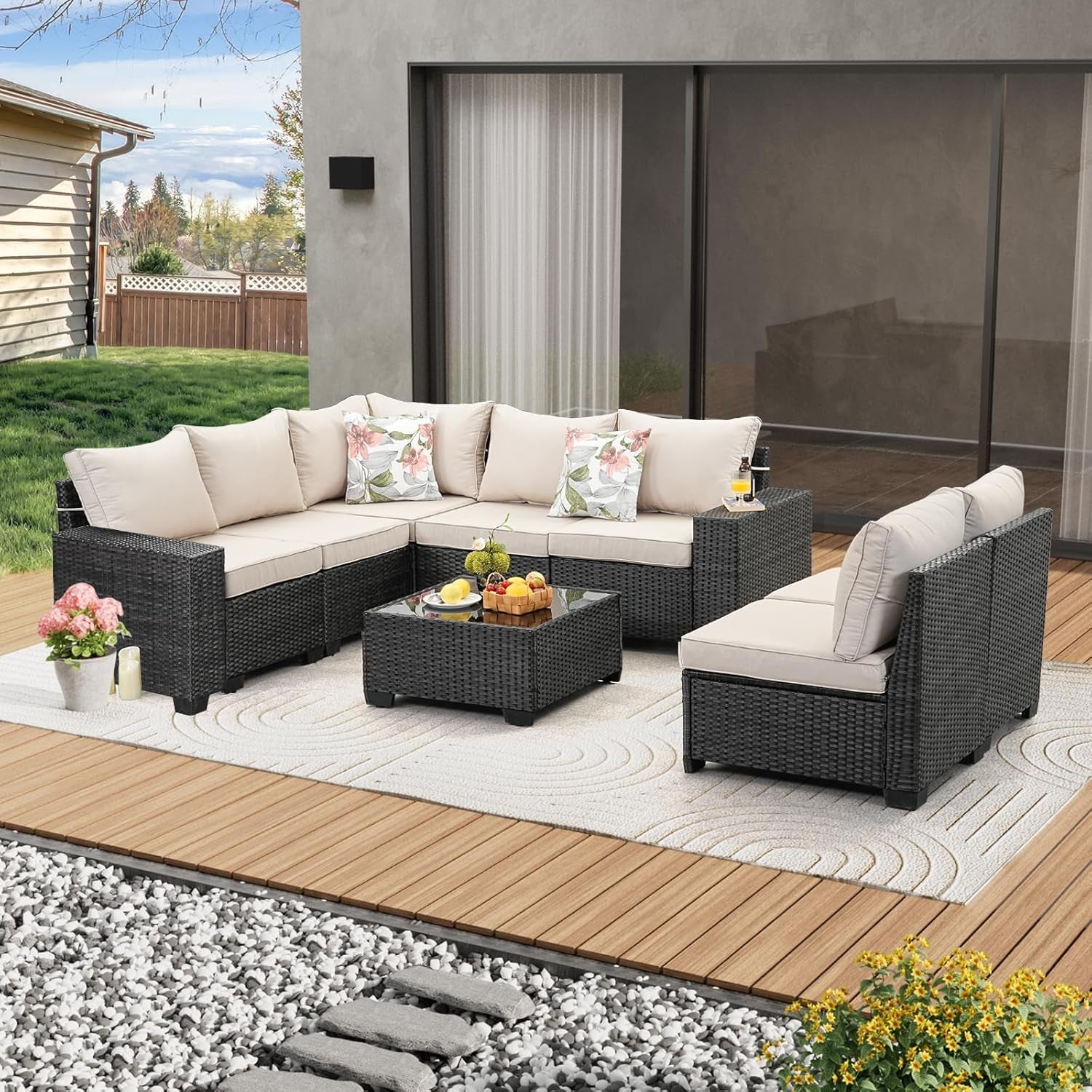 Outdoor patio furniture set with cushions on a wooden deck.
