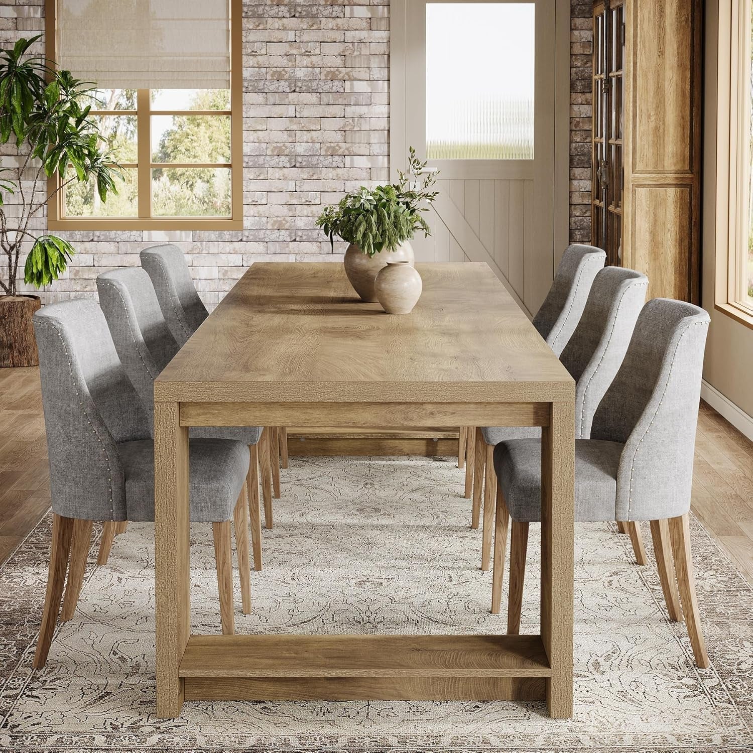Dining room with wooden table and gray chairs in a well-lit room.