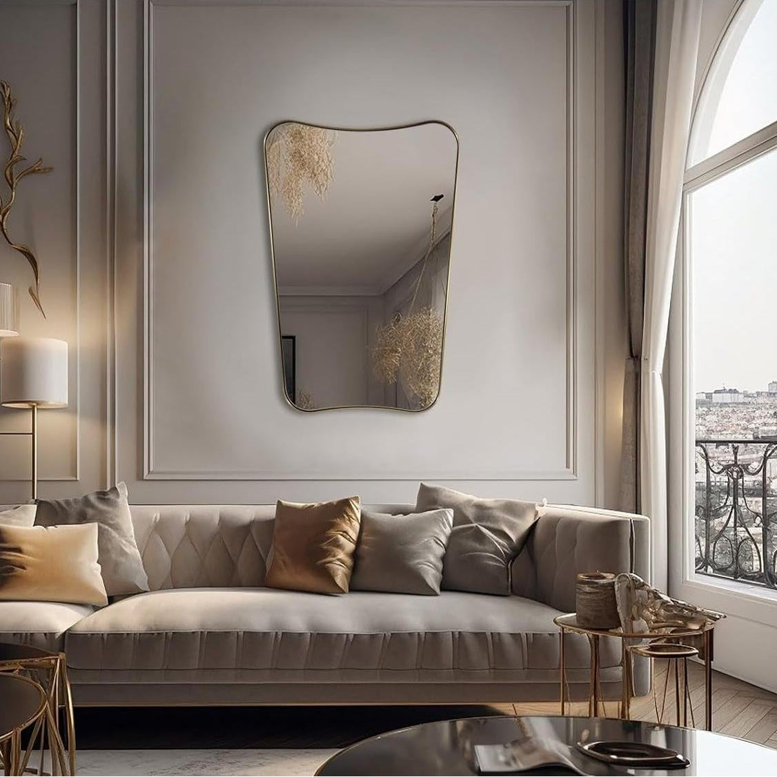 Modern living room with a gray sofa, decorative mirror, and large window.
