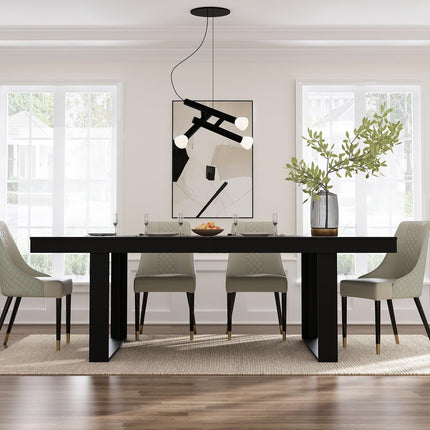 Modern dining room with a black table and gray chairs, featuring a abstract painting on the wall.