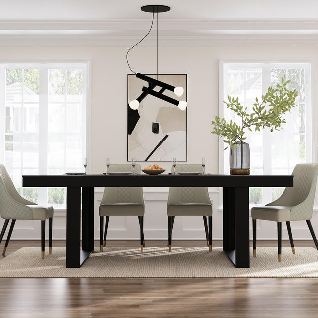 Modern dining room with a black table and gray chairs, featuring a abstract painting on the wall.