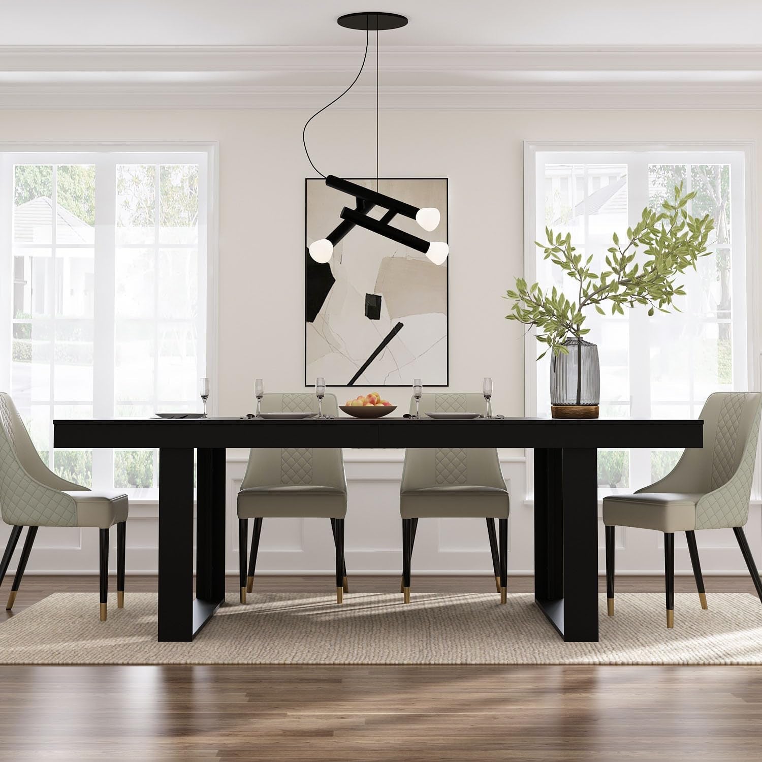 Modern dining room with a black table and gray chairs, featuring a abstract painting on the wall.