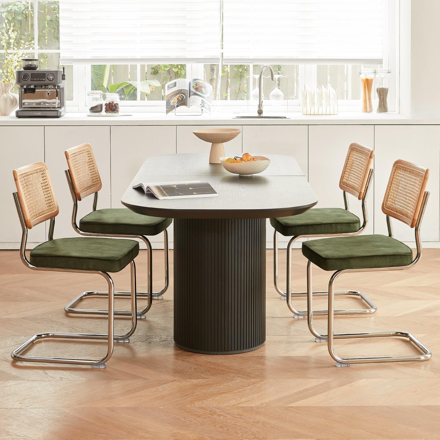 Dining area with a round table and four chairs in a kitchen setting.