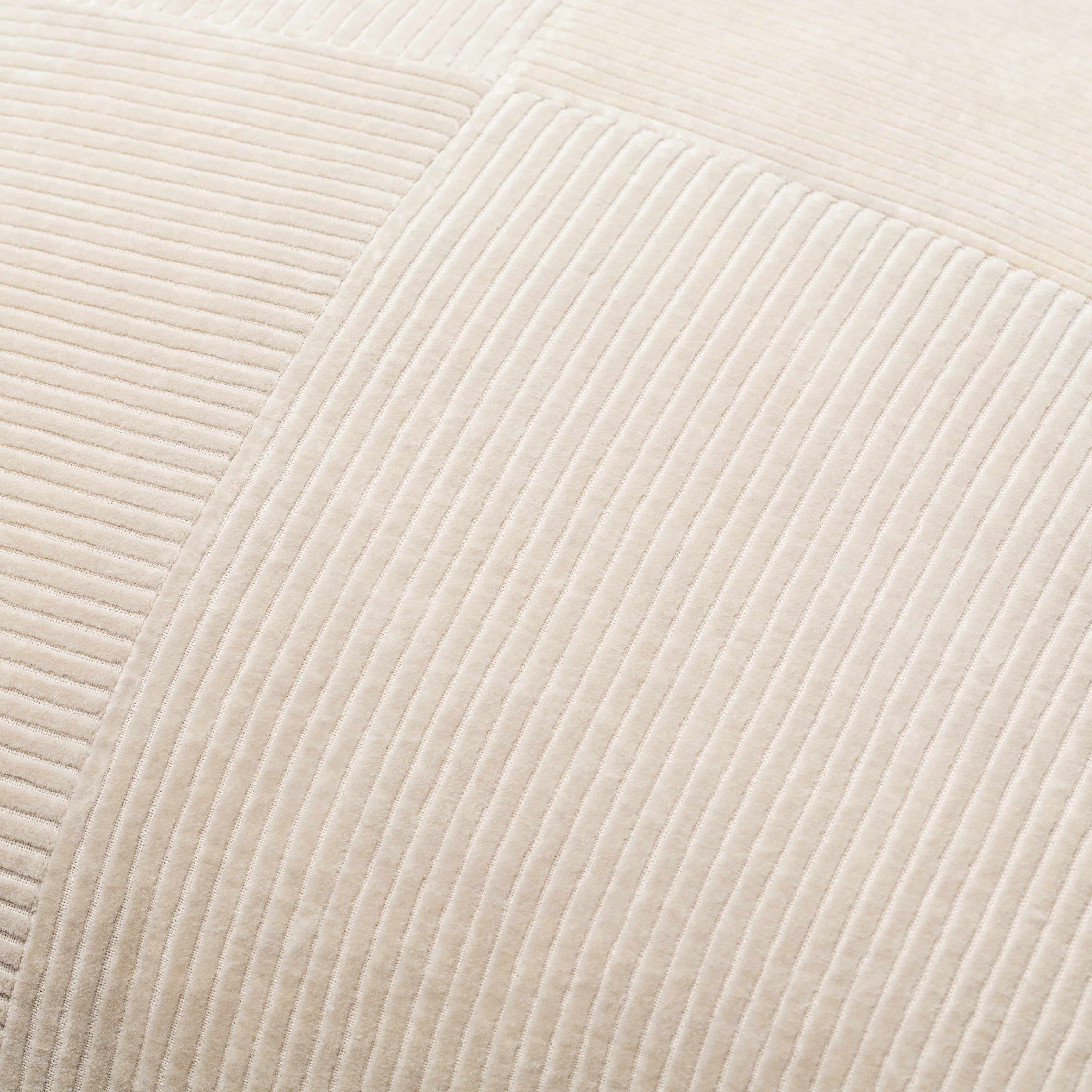 Close-up of beige textured fabric with a subtle pattern