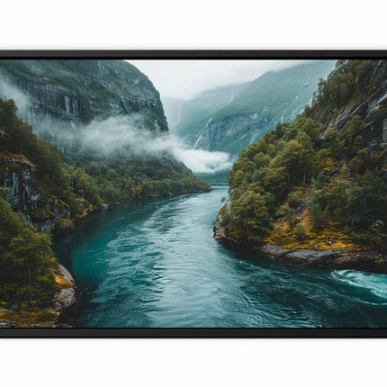 Framed photograph of a mountainous landscape with a river and misty mountains.