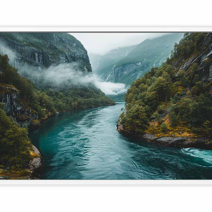 Framed photograph of a scenic landscape with a river surrounded by mountains and trees.