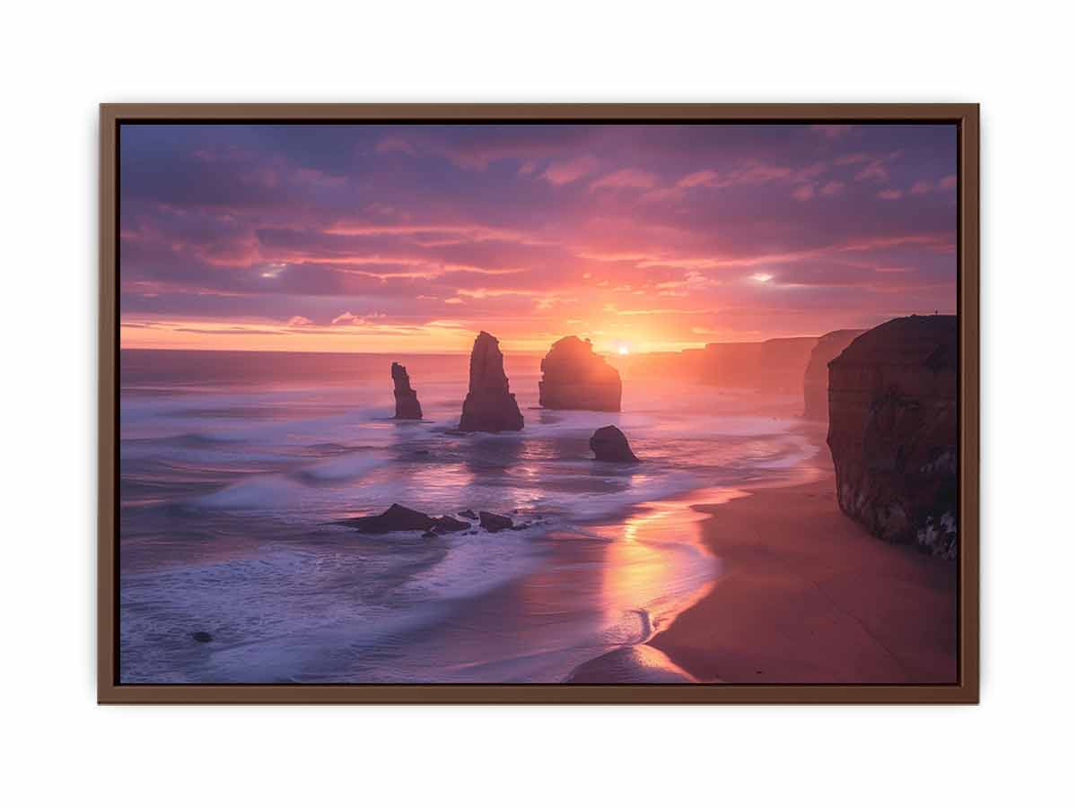 Framed artwork of a sunset over a beach with rocks.