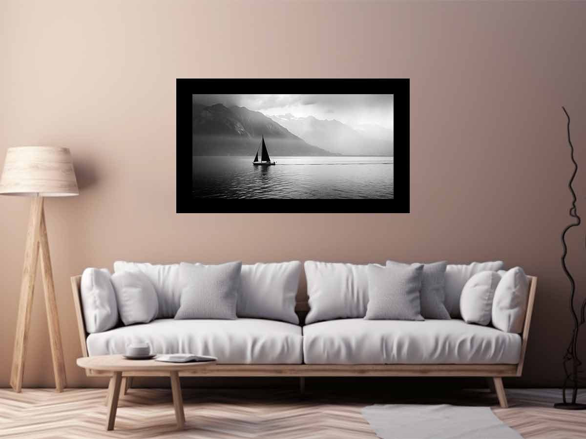 Living room with a white sofa, wooden coffee table, and a framed black and white painting of a sailboat on a wall.