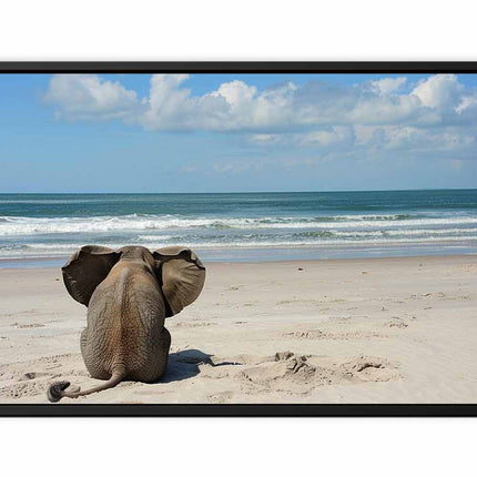 Framed artwork of an elephant on a beach with ocean and sky in the background