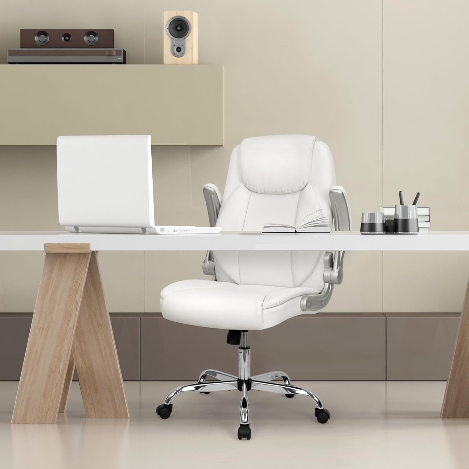 Modern office setup with a white chair, desk, and laptop in a minimalistic room.