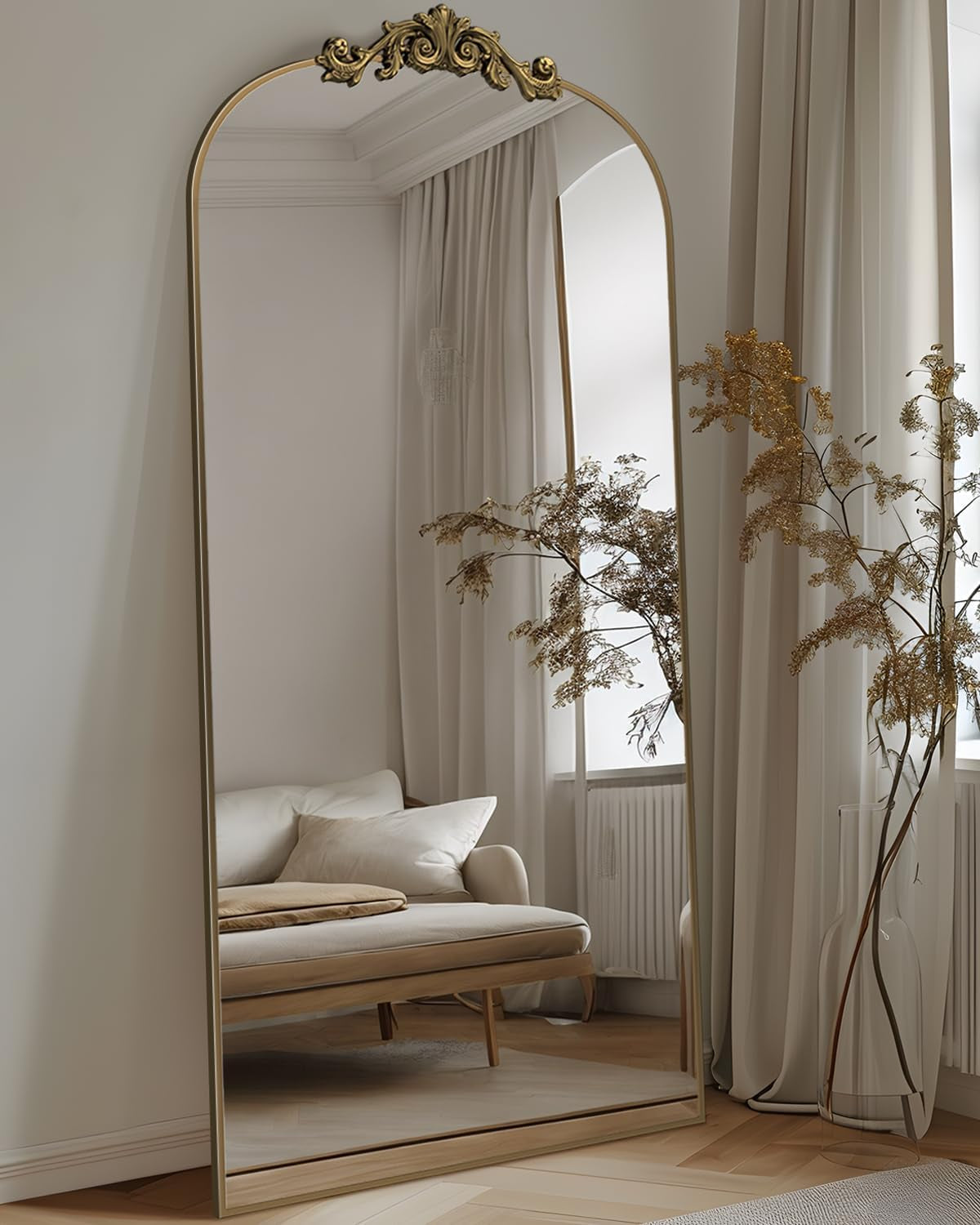 Decorative full-length mirror with gold frame in a room with a sofa and curtains.