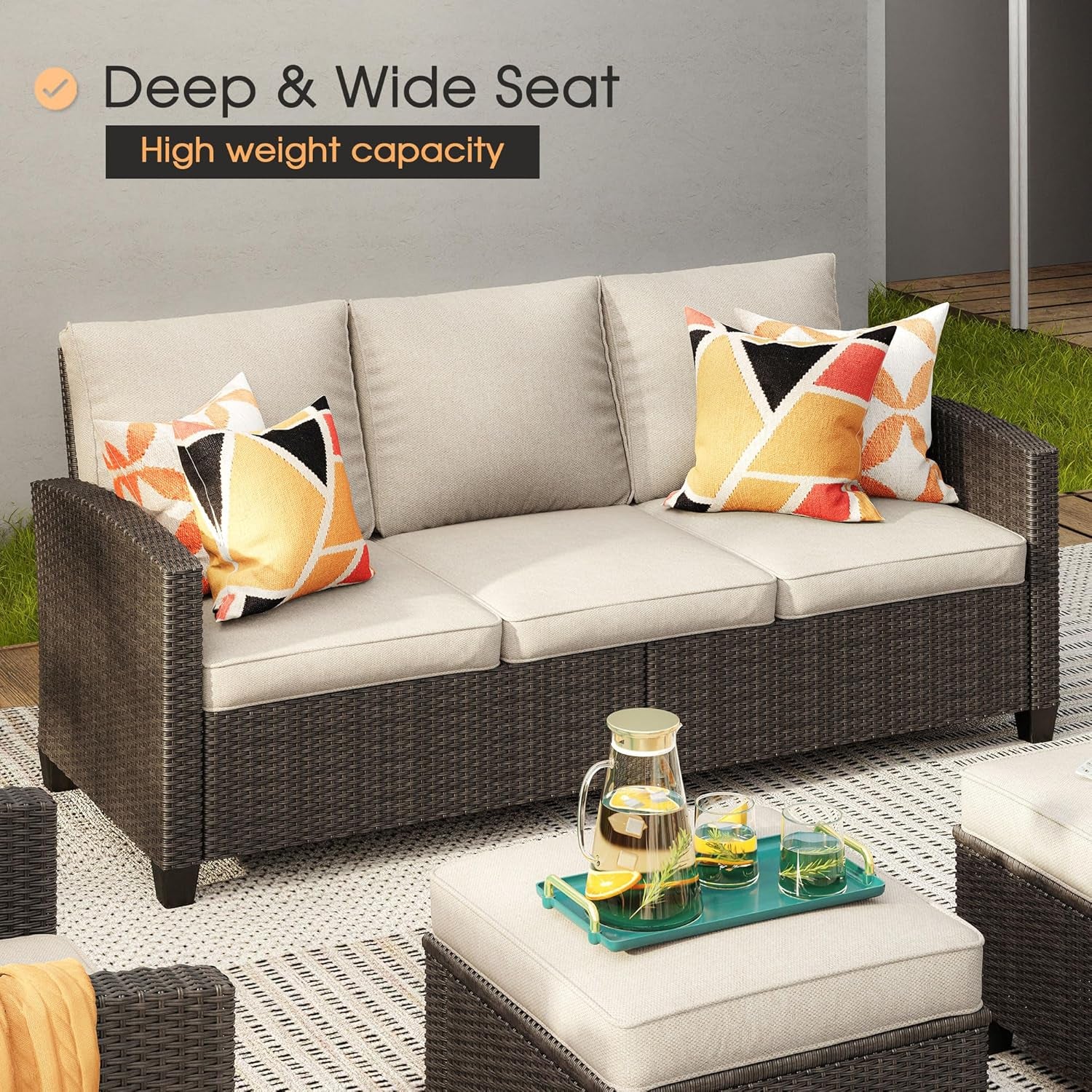 Outdoor sofa with cushions and a small table with drinks on a patio.