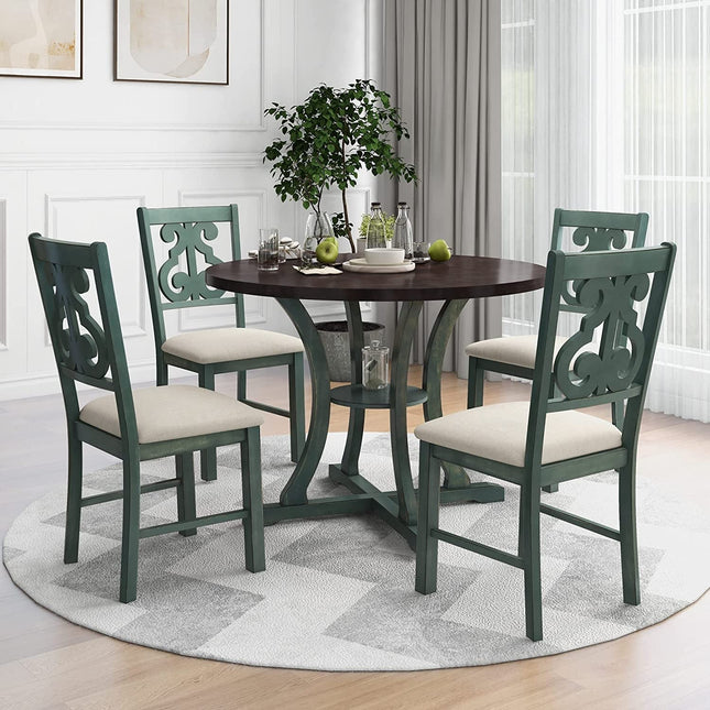 Dining room set with a round table and four green chairs on a rug.