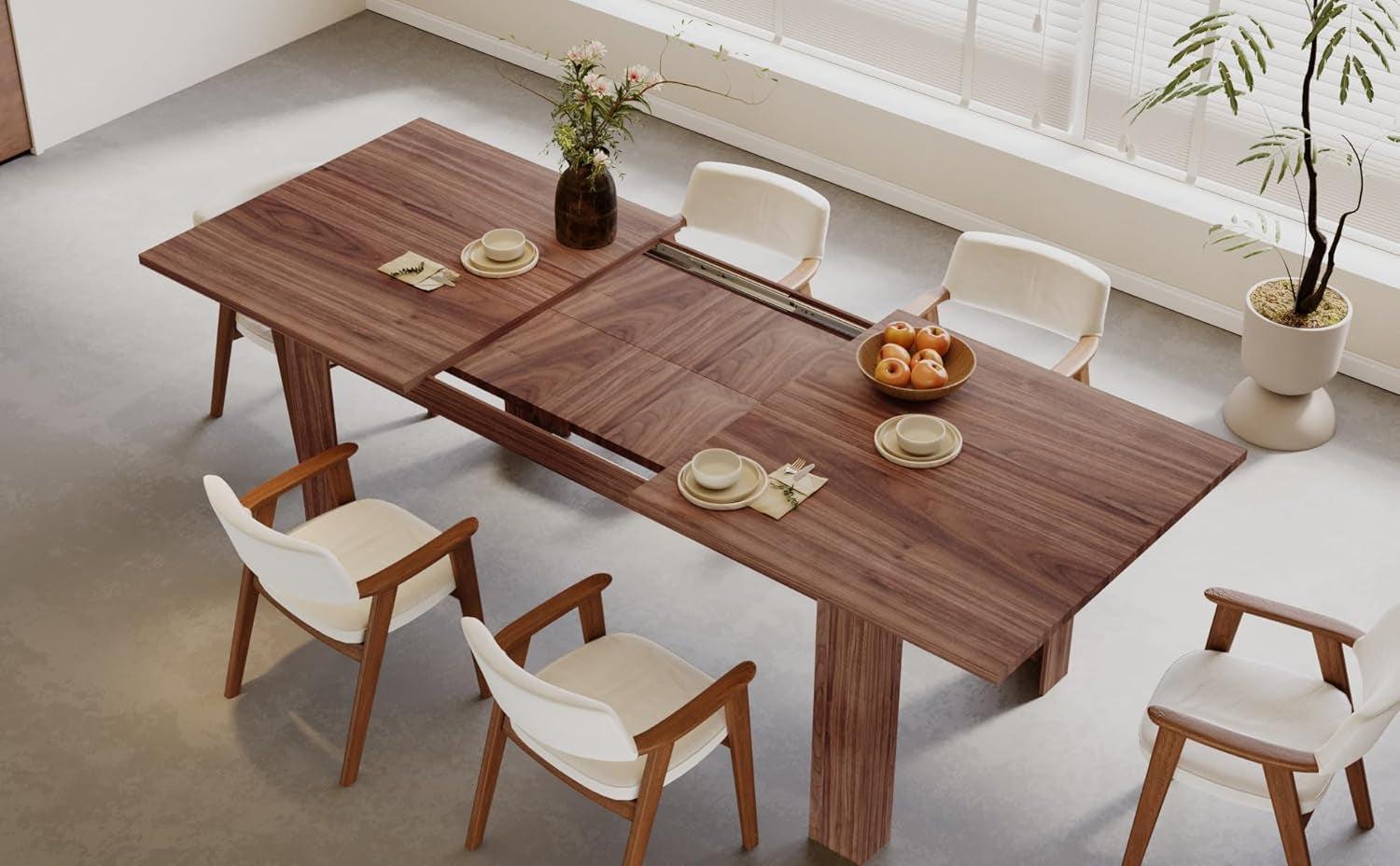 Wooden dining table with extendable leaves in a modern kitchen setting.