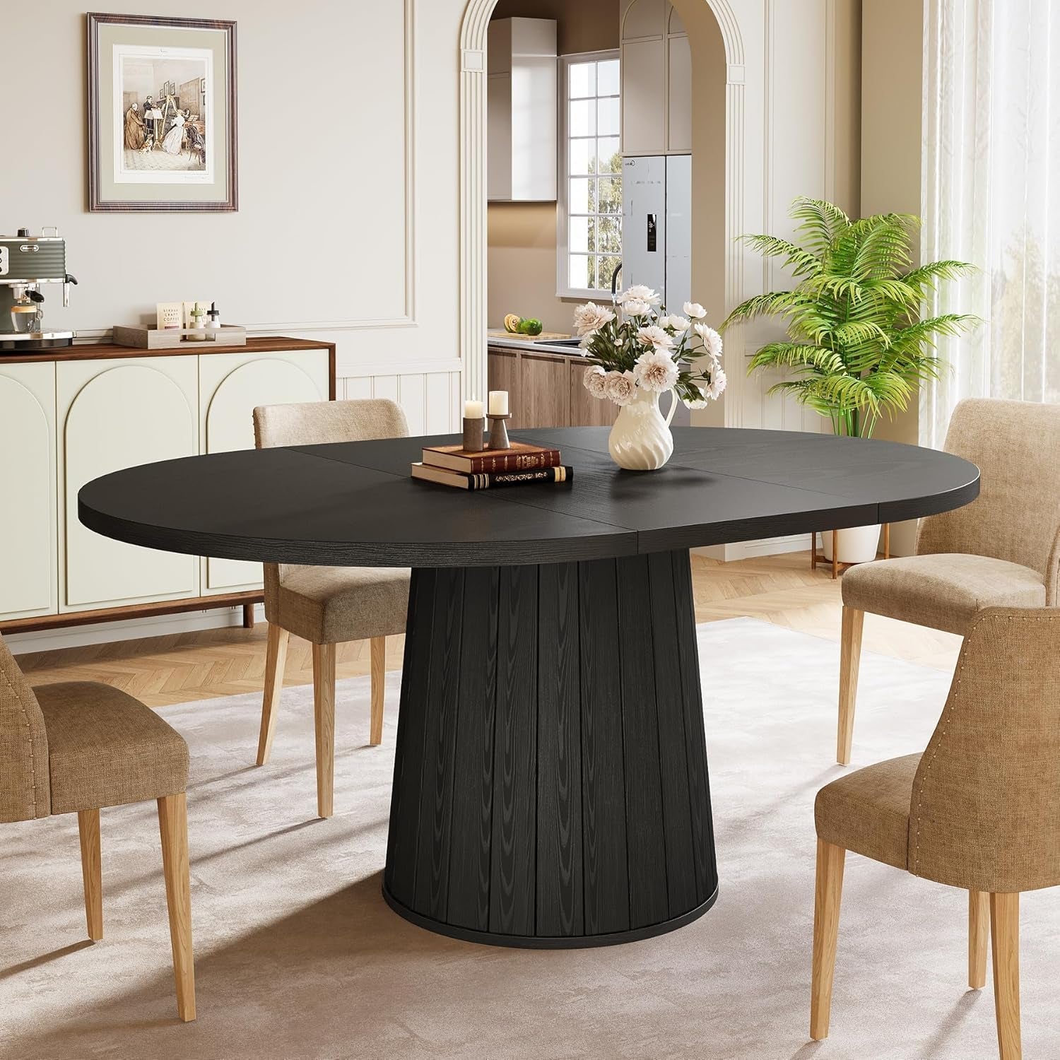 Dining room with a black round table and beige chairs.