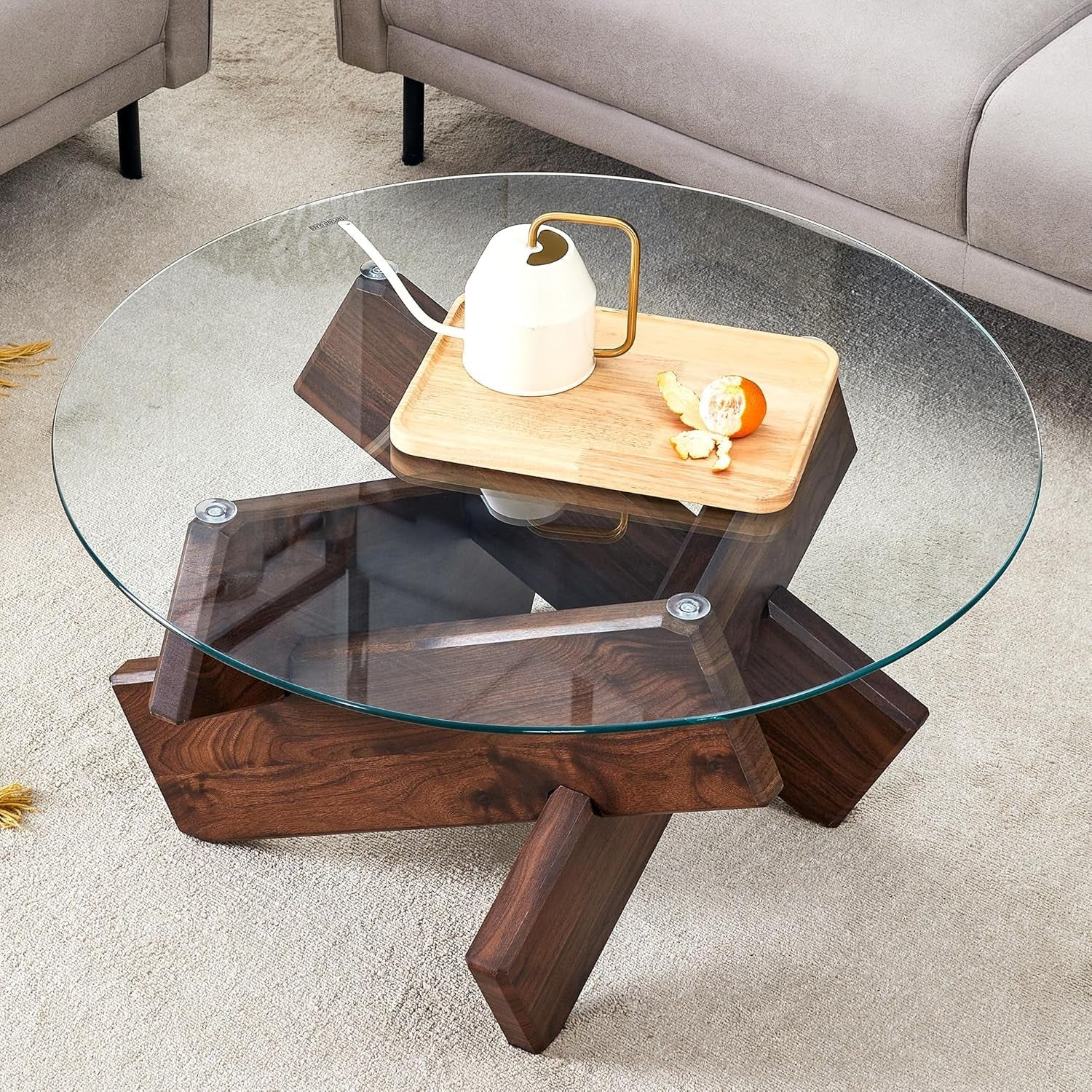 Glass coffee table with wooden base in a living room setting