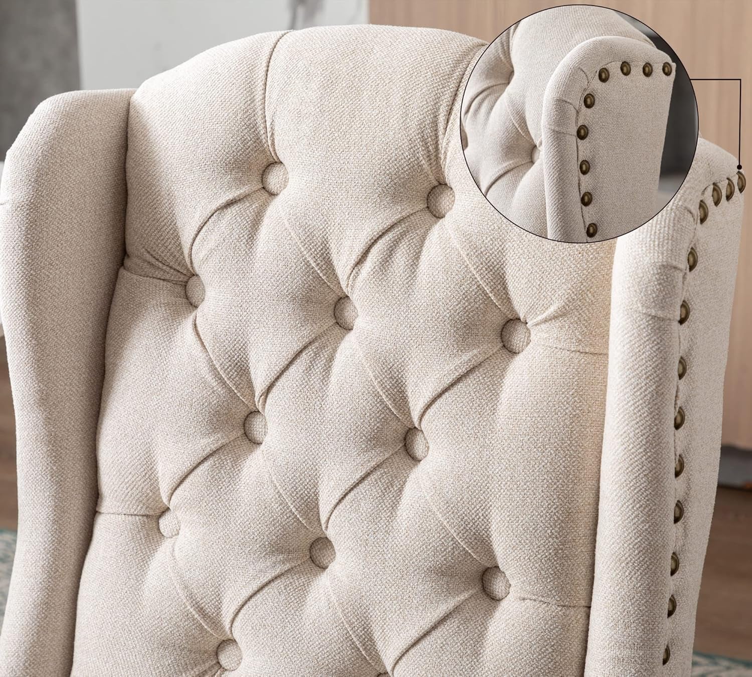 Beige upholstered chair with tufted backrest and button details.