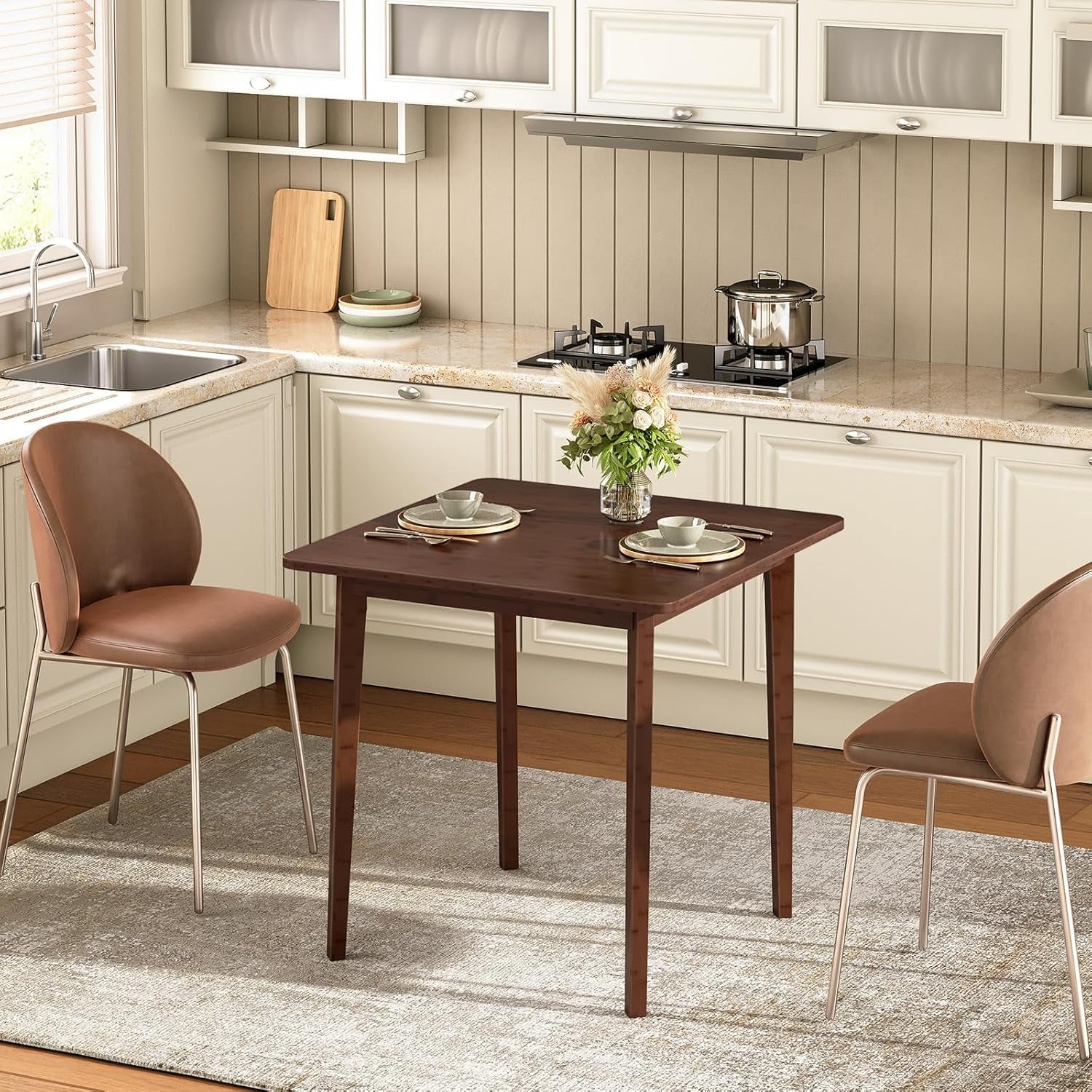 Kitchen with a wooden dining table and chairs, featuring a kitchen sink and cabinets in the background.