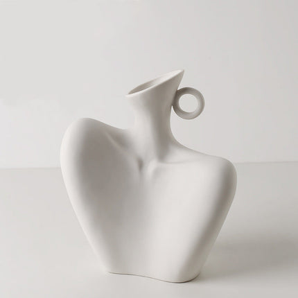 White ceramic vase with a unique design on a light gray background