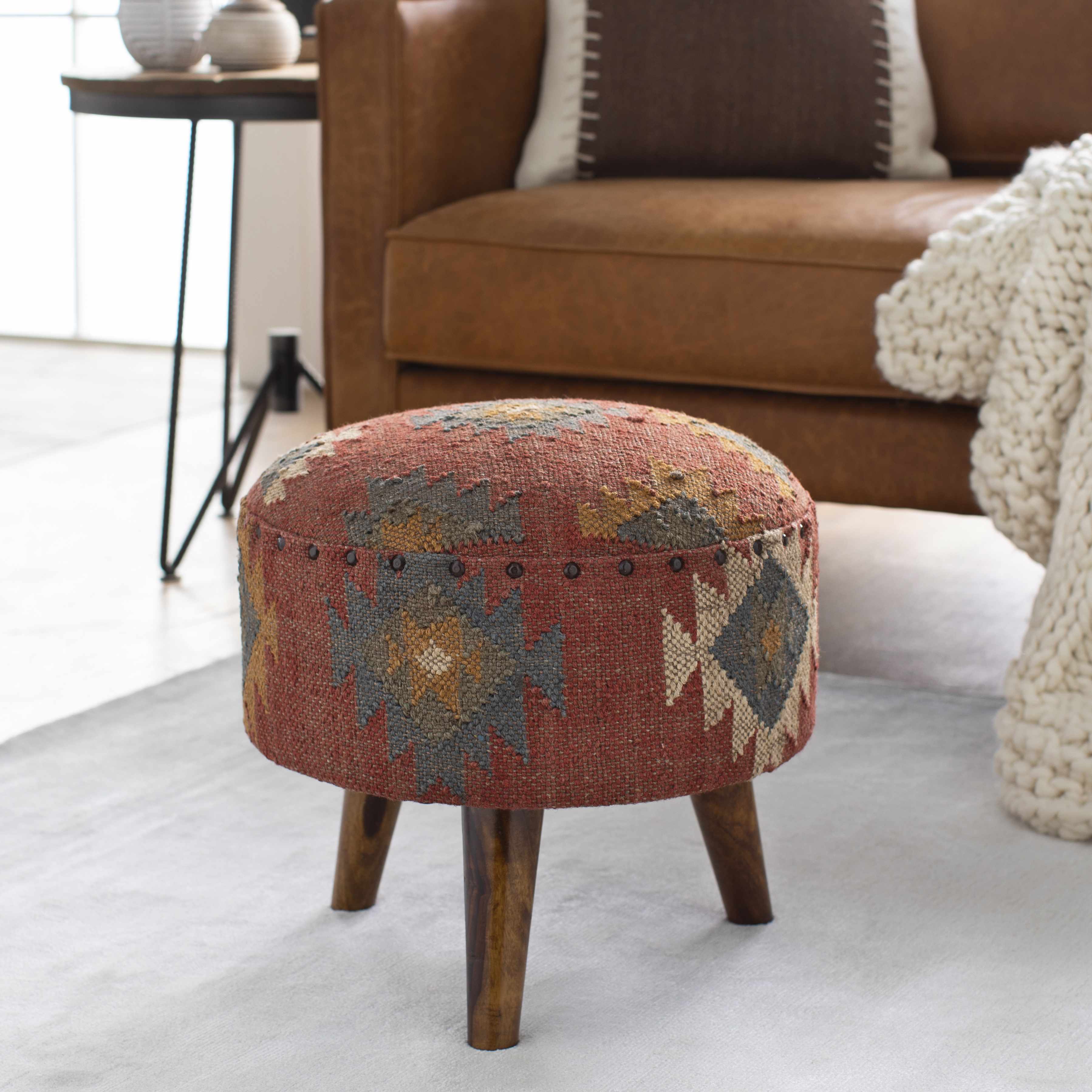 Decorative ottoman with patterned top in a living room setting