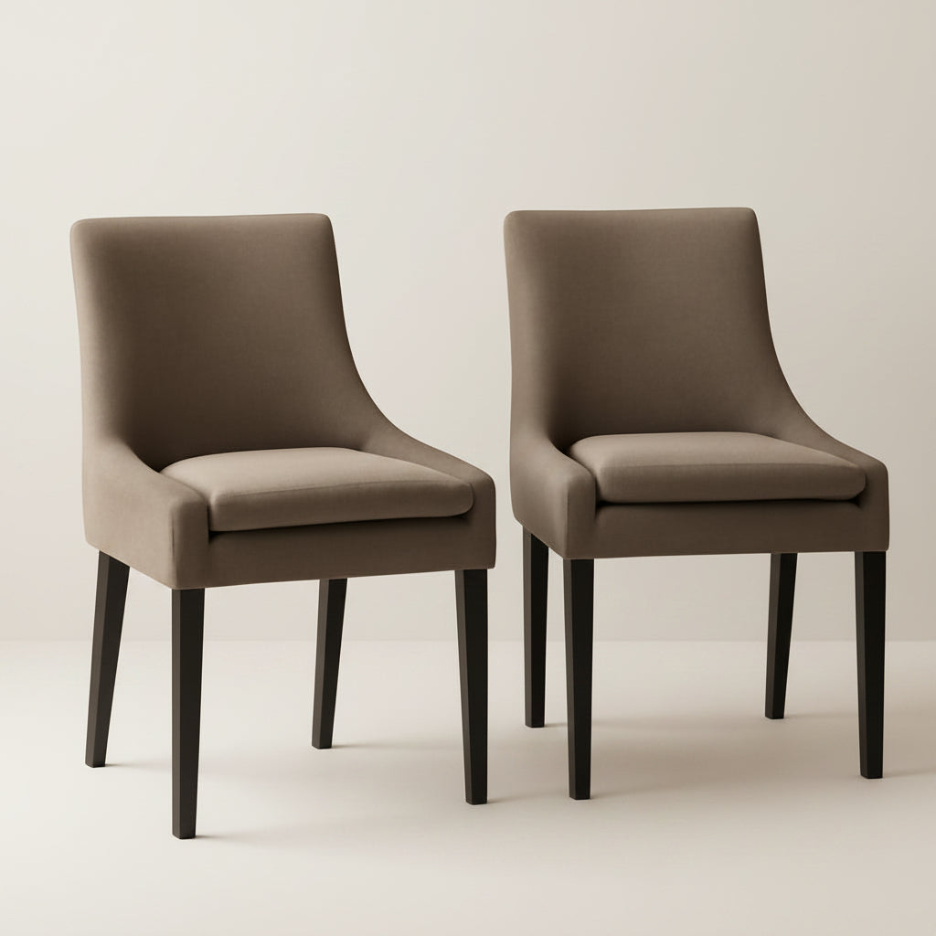 Two brown chairs on a beige rug with a neutral wall background