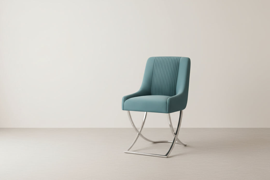 Two teal chairs with metal legs in a room with a beige wall and rug.