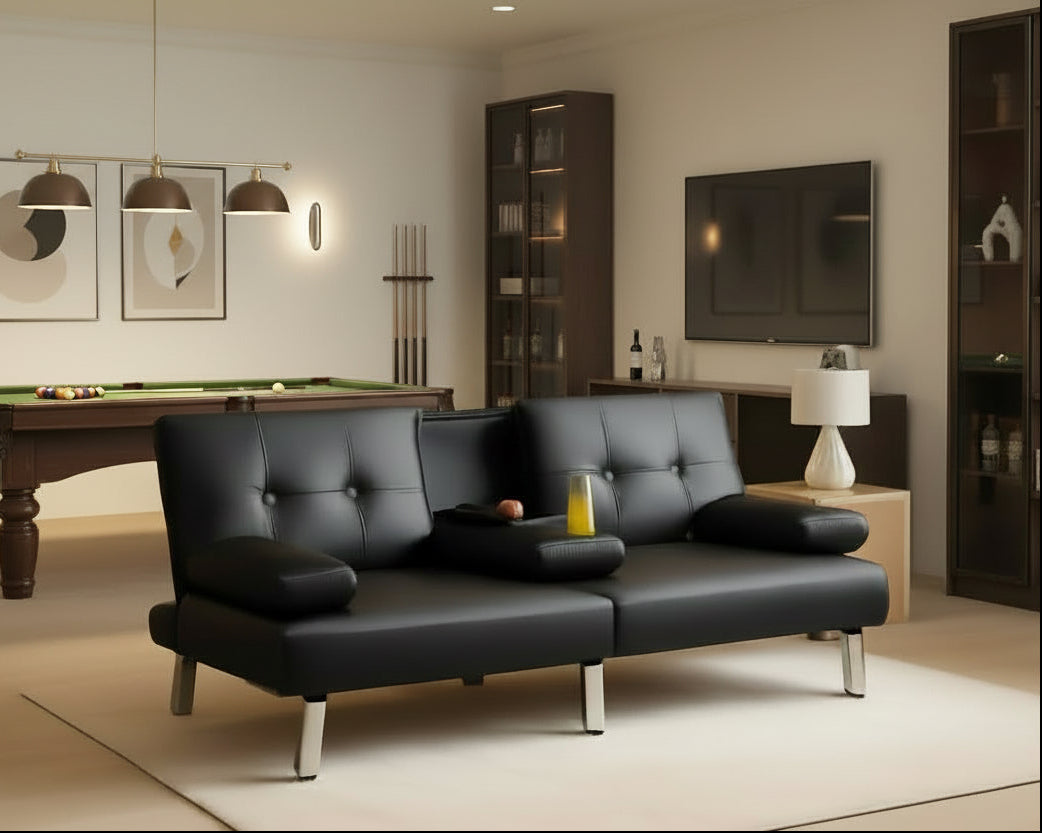 Black leather sofa in a living room with beige walls and a lamp.