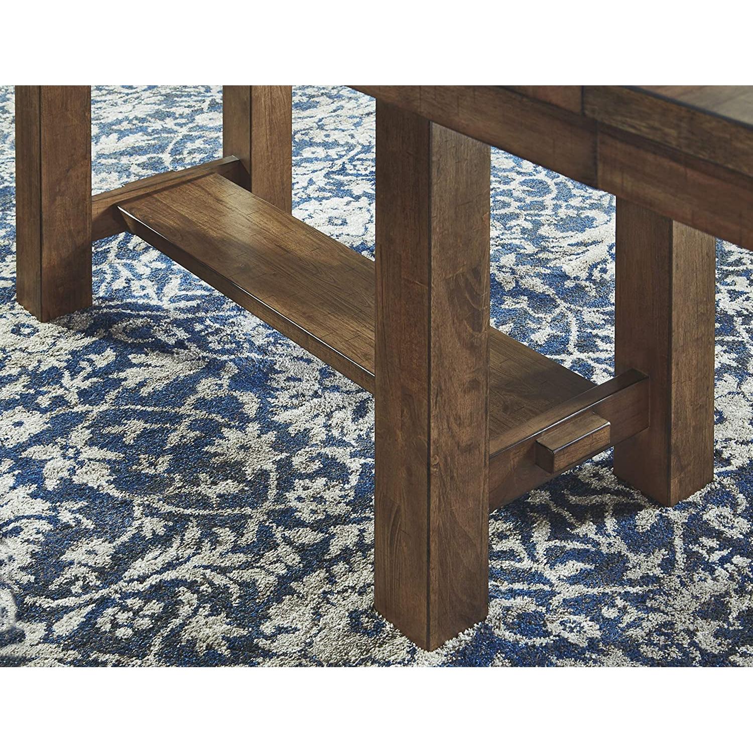 Wooden table leg on a blue and white patterned rug